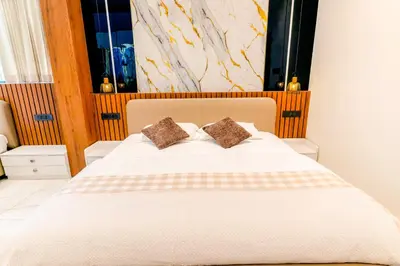a bedroom with a large white bed with two pillows at AE Tower Platinum Retreat in Sultan Bathery