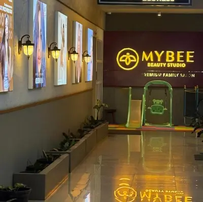 a lobby with a sign and plants on the wall at AE Tower Platinum Retreat in Sultan Bathery