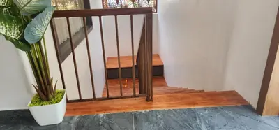 a stairway with a wooden railing and a plant at Itria private pool villa in Pinangode