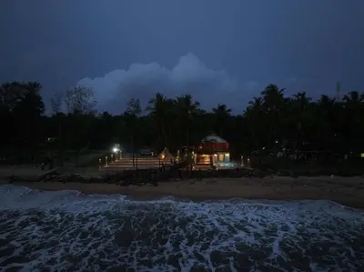 a house on the beach at night at Bougainvillea Beach Home - Guruvayur - Chavakkad in Manattala