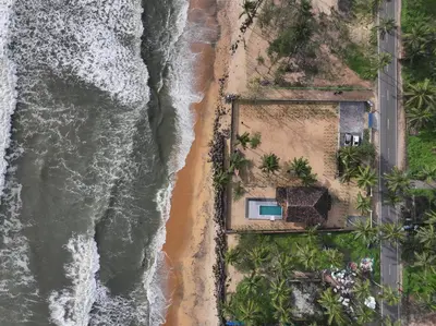 an overhead view of the beach and ocean at Bougainvillea Beach Home - Guruvayur - Chavakkad in Manattala