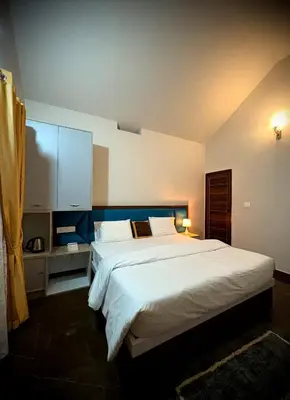 a bedroom with a large bed in a room at Riparian Inn Resort in Chekadi