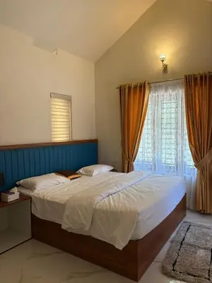 a bedroom with a large bed and a window at Riparian Inn Resort in Chekadi