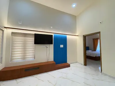 a room with a flat screen tv on a wall at Riparian Inn Resort in Chekadi