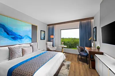 a hotel room with a bed and a large window at Fortune Airport Road Kochi - Member ITC hotels' group in Cochin
