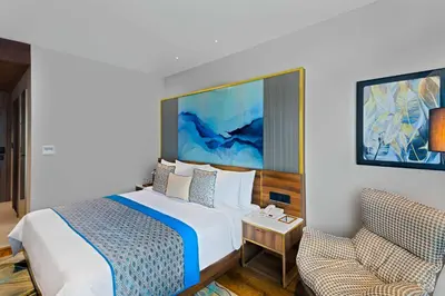 a hotel room with a bed and a chair at Fortune Airport Road Kochi - Member ITC hotels' group in Cochin