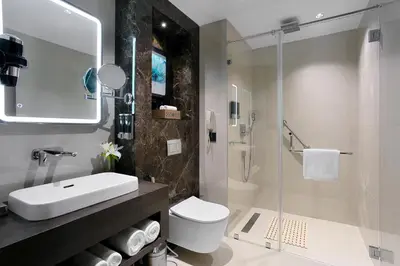 a bathroom with a sink and a toilet and a shower at Fortune Airport Road Kochi - Member ITC hotels' group in Cochin