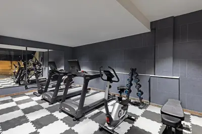 a gym with several tread machines in a room at Fortune Airport Road Kochi - Member ITC hotels' group in Cochin