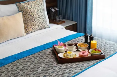 a tray of food on top of a bed at Fortune Airport Road Kochi - Member ITC hotels' group in Cochin