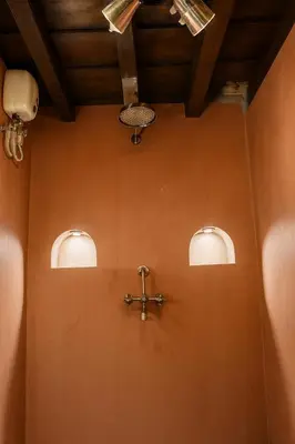 a room with three lights and a cross on the wall at Seclude Karthika Nivas, Thrissur in Trichūr