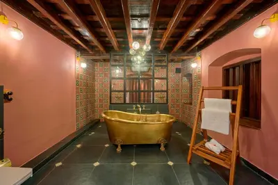 a bathroom with a copper tub in a room at Seclude Karthika Nivas, Thrissur in Trichūr