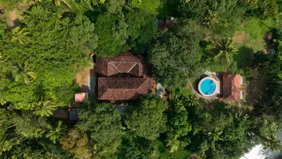 an overhead view of a house and a pool in the forest at Seclude Karthika Nivas, Thrissur in Trichūr