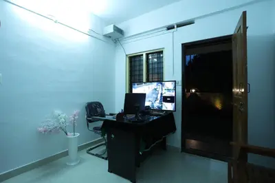 an office with a desk with a computer on it at Emberlin Holidays in Wayanad
