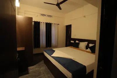 a bedroom with a bed and a ceiling fan at Emberlin Holidays in Wayanad