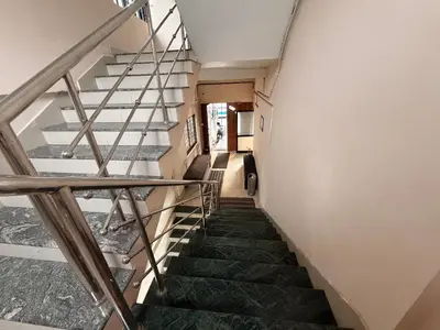 a staircase in a house with green stairs at Moon Way in Neriyamangalam
