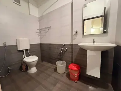a bathroom with a sink and a toilet and a mirror at Moon Way in Neriyamangalam
