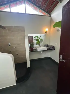 a bathroom with a sink and a toilet in a room at Sky Holiday Homestay Cottages Madikeri Kushalnagar Coorg in Kushālnagar