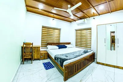 a bedroom with a bed and a desk and a window at vintage inn in Kommeri