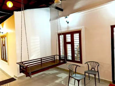 a room with two chairs and a swing at vintage inn in Kommeri
