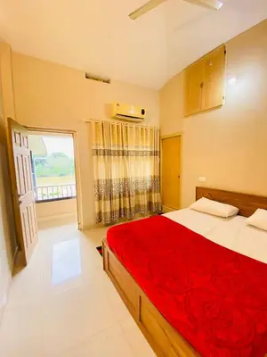 a bedroom with a large bed with a red blanket at Verito Home Stay