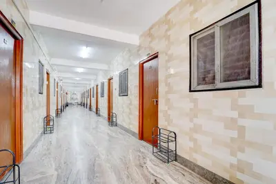 an empty hallway in a building with wooden walls at Super Collection O Avarampalayam Bus Stop Formerly Krish Castle in Coimbatore