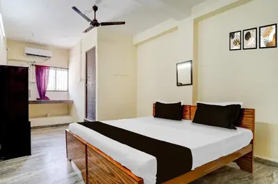 a bedroom with a large bed in a room at Super Collection O Avarampalayam Bus Stop Formerly Krish Castle in Coimbatore