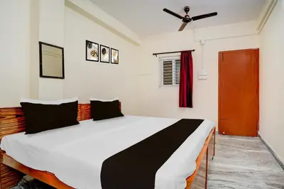 a bedroom with a large bed in a room at Super Collection O Avarampalayam Bus Stop Formerly Krish Castle in Coimbatore