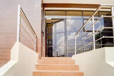 an open glass door to a building with stairs at Super Collection O Avarampalayam Bus Stop Formerly Krish Castle in Coimbatore