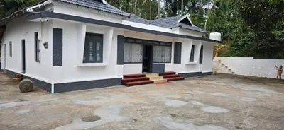 a small white house with red steps in front of it at The Coffee Cube in Kaniyāmbetta