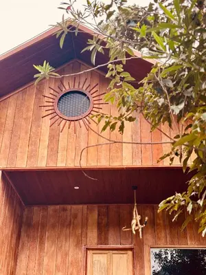 a wooden house with a window and a door at FAMILY RESORT MARAYOoR KANTHALLOOR in Kanthalloor