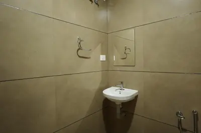 a bathroom with a sink and a mirror at Papilio Mudhouse Stay in Edayūr
