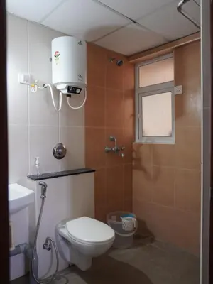 a small bathroom with a toilet and a window at Pearl Home Luxury 3Bhk family-friendly Appartment in Mysore