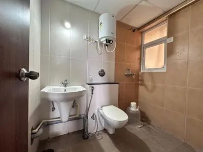 a bathroom with a toilet and a sink at Pearl Home Luxury 3Bhk family-friendly Appartment in Mysore