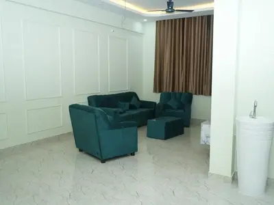 a living room with two chairs and a couch at Serene Legacy in Mysore