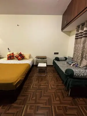 a room with two beds in a room at Sihi-2 bhk Non AC and Penthouse AC Rooms in Mysore