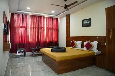 a bedroom with a bed and a red curtain at Athithi Comforts in Mysore