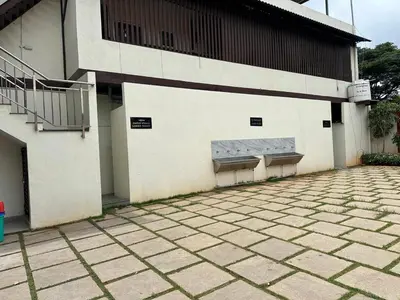two benches on the side of a building at Athithi Comforts in Mysore