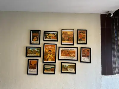 a group of framed movies on a wall at Athithi Comforts in Mysore