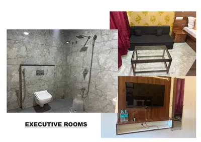 a bathroom with a shower and a toilet and a couch at Athithi Comforts in Mysore