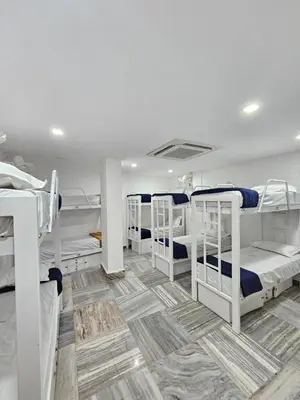 a dorm room with four bunk beds in it at Lowfare Dormitory in Kozhikode