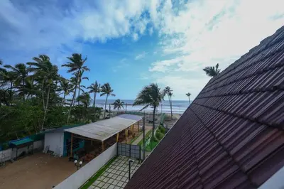 a view of the beach from the roof of a building at Vadanapilly Beach Villa for 8-10 adults in Irimbranallūr