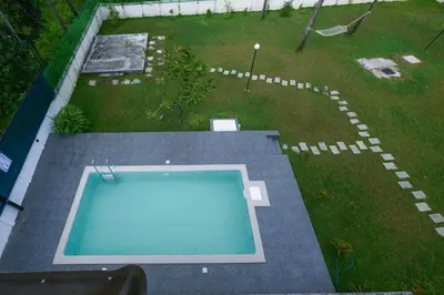 an overhead view of a swimming pool in a yard at Vadanapilly Beach Villa for 8-10 adults in Irimbranallūr