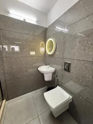 a bathroom with a toilet and a sink at Vadanapilly Beach Villa for 8-10 adults in Irimbranallūr