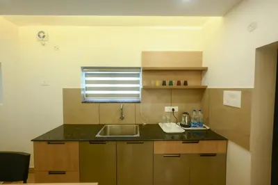 a small kitchen with a sink and a window at Vadanapilly Beach Villa for 8-10 adults in Irimbranallūr