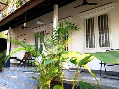 a porch of a house with some plants on it at Private 1BHK Kerala Village Homestay with Open Veranda near Thrissur in Cheruthuruthi