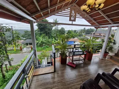 a view from the balcony of a house with plants at Coorg Coffee Tales in Suntikoppa