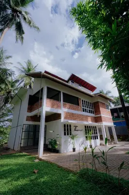 a house with the name tamasha on it at Thiraa Inn Nilambur By Hotelbuz in Nilambūr