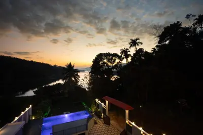 a view of a river at sunset from a house at Lake Paradise Resort in Padinjarathara