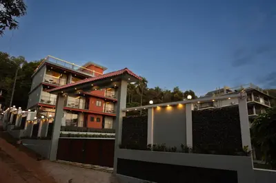 a fence in front of a building with a gate at Lake Paradise Resort in Padinjarathara