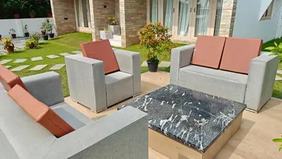 three chairs and a table on a patio at Cherai Beach Regency in Ernakulam